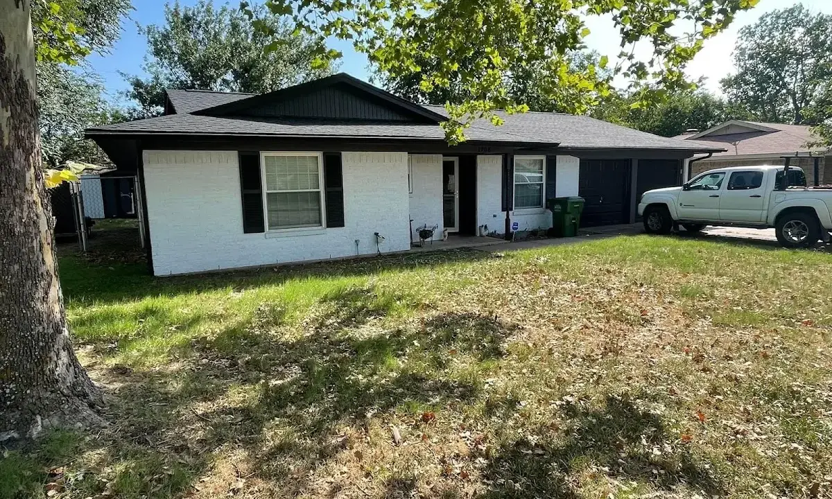 Professional roofing crew working on a residential roof in Lewisburg